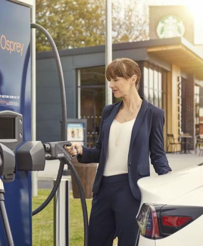 Woman charging EV at Osprey location