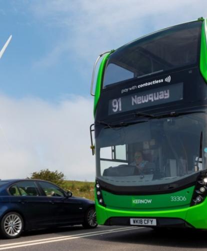 First bus in front of wind farm