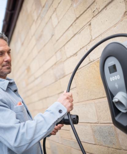 Man handling EV home charger